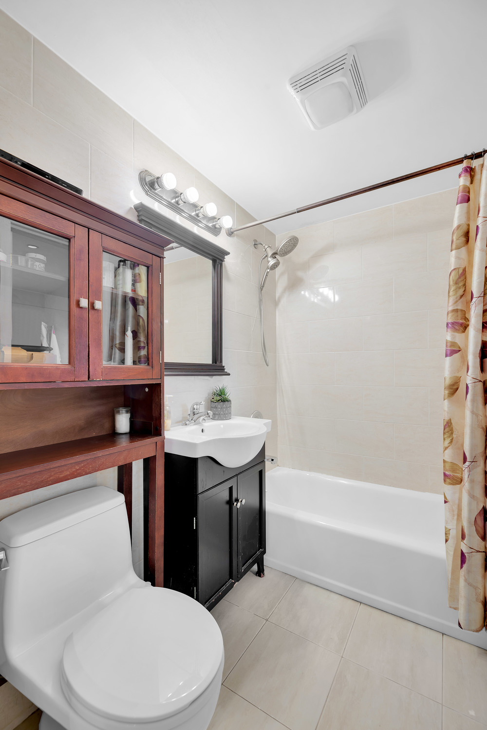 43-33 42nd Street, Unit 6B Queens, NY 11104 - Photo 7 of 8 a bathroom with a sink toilet and shower