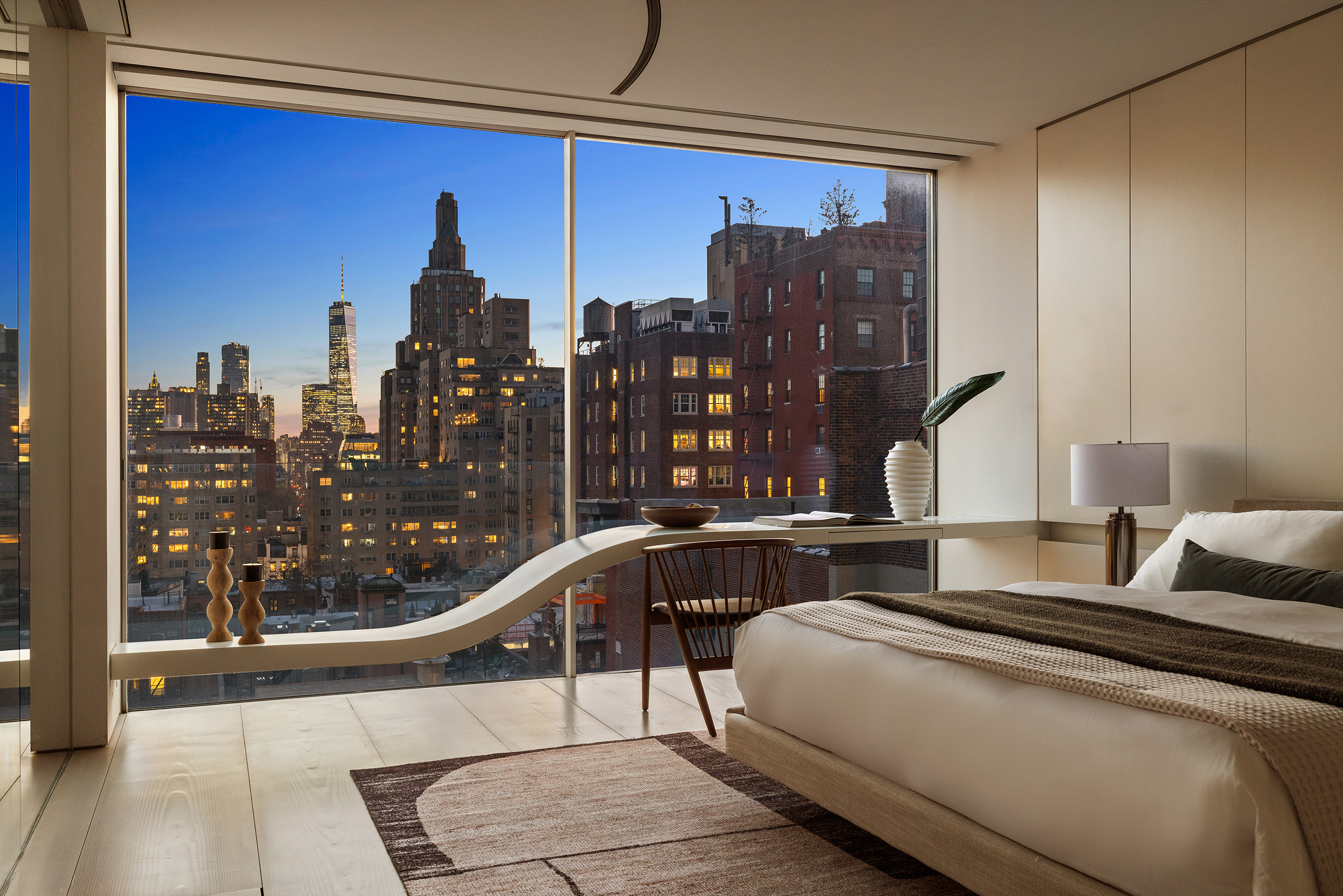 12 East 12th Street, Unit 9NS Manhattan, NY 10003 - Photo 12 of 21 a bedroom with a large bed and a chandelier