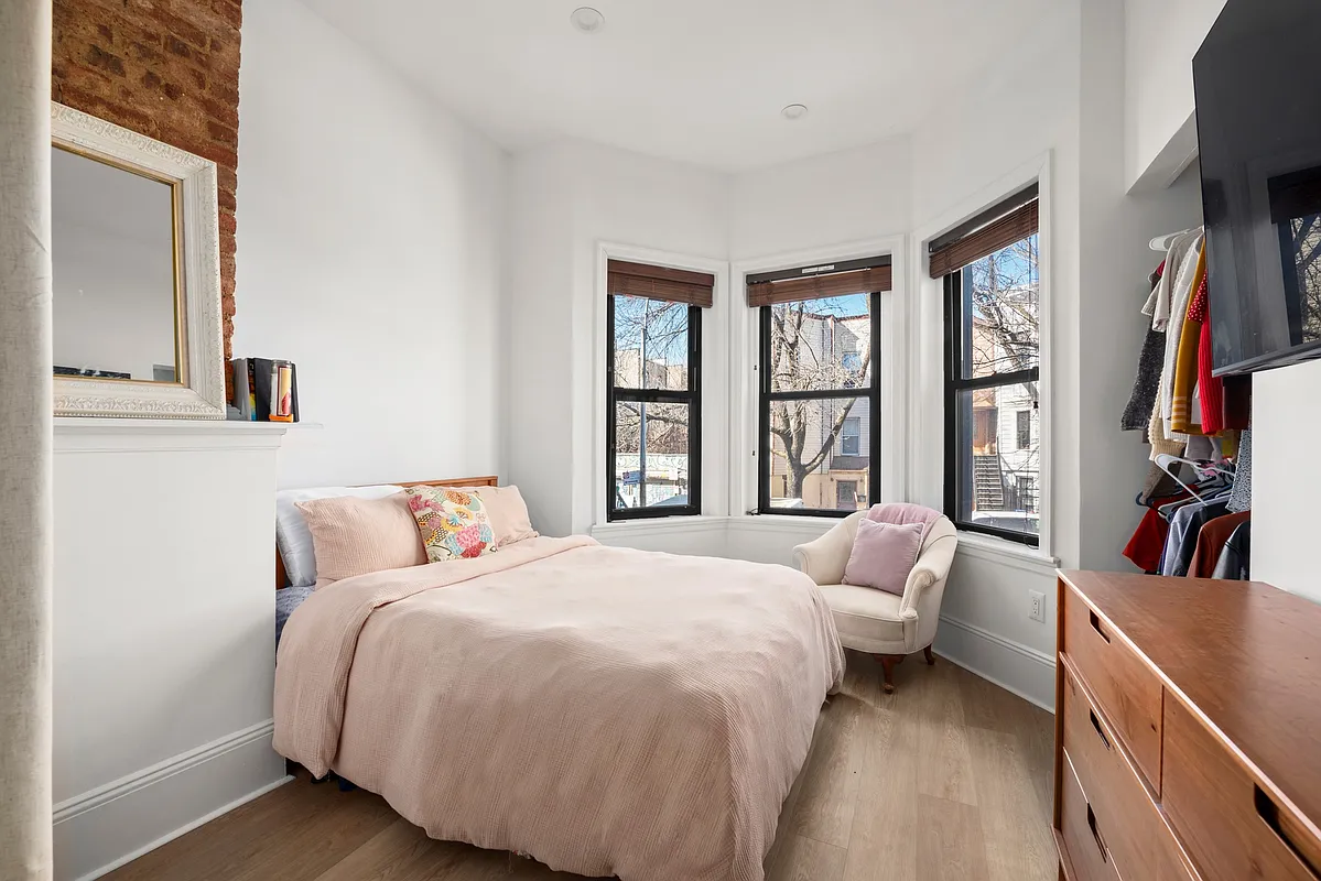 1316 Jefferson Avenue, Unit 2 Brooklyn, NY 11221 - Photo 4 of 10 a bedroom with a bed wooden floor and a window