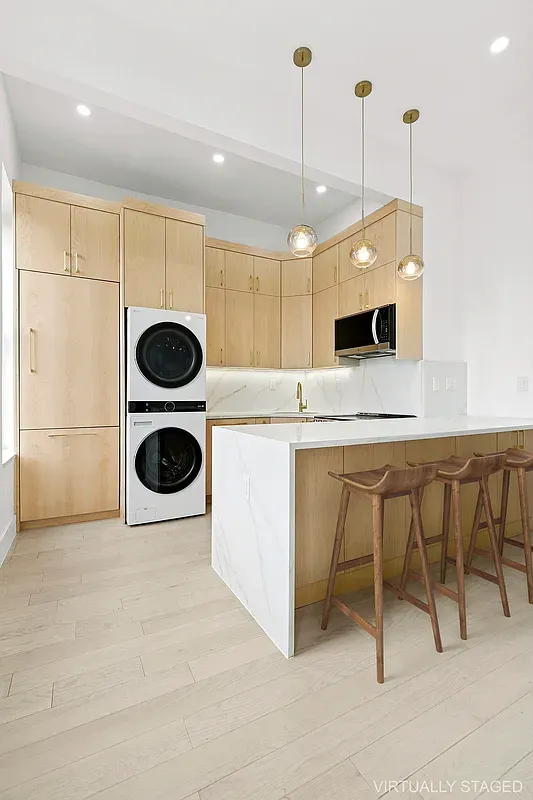 a kitchen with a refrigerator a microwave and a table