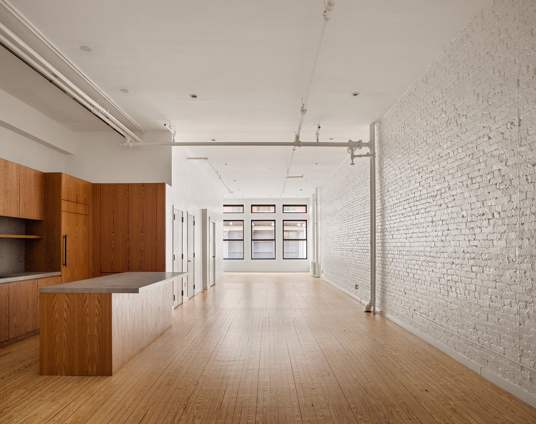 169 Mercer Street, Unit 2 Manhattan, NY 10012 - Photo 1 of 10 a view of a kitchen with wooden floor