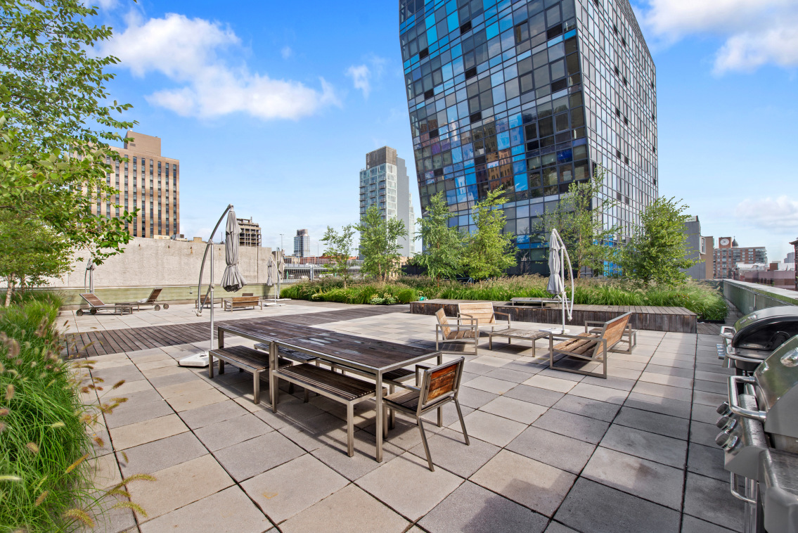 105 Norfolk Street, Unit 2A Manhattan, NY 10002 - Photo 14 of 16 a view of a patio with a table and chairs and potted plants