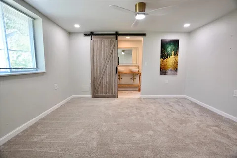 an empty room with windows and cabinet