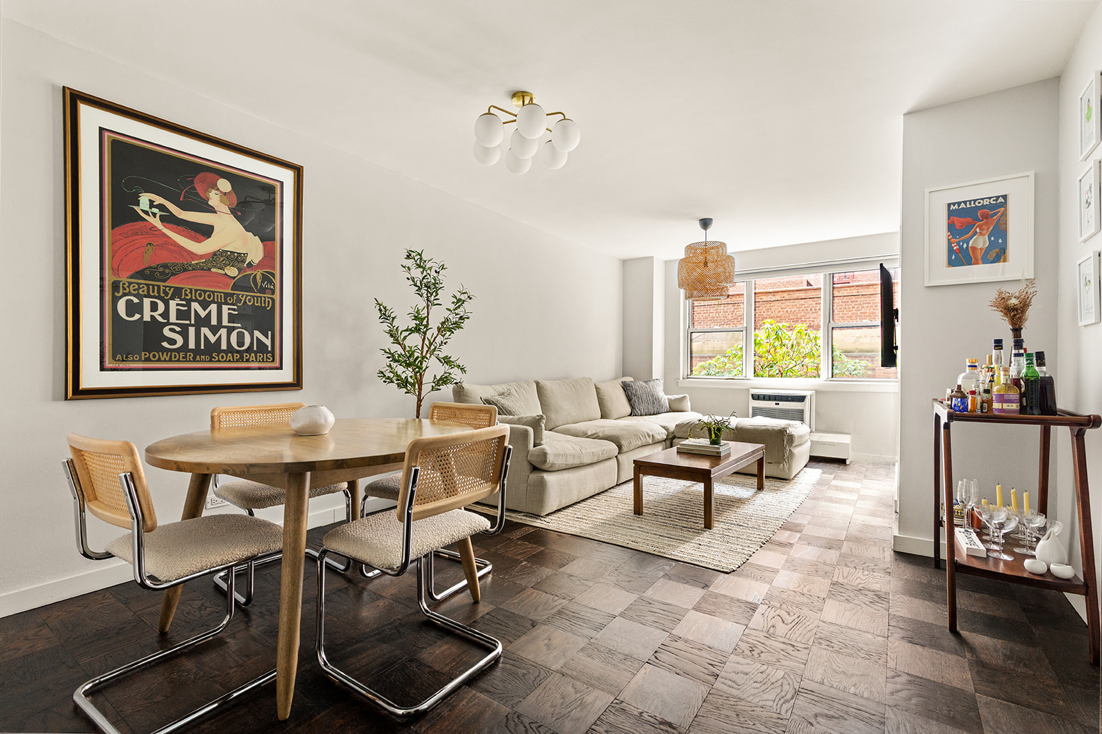 a living room with furniture a window and a potted plant