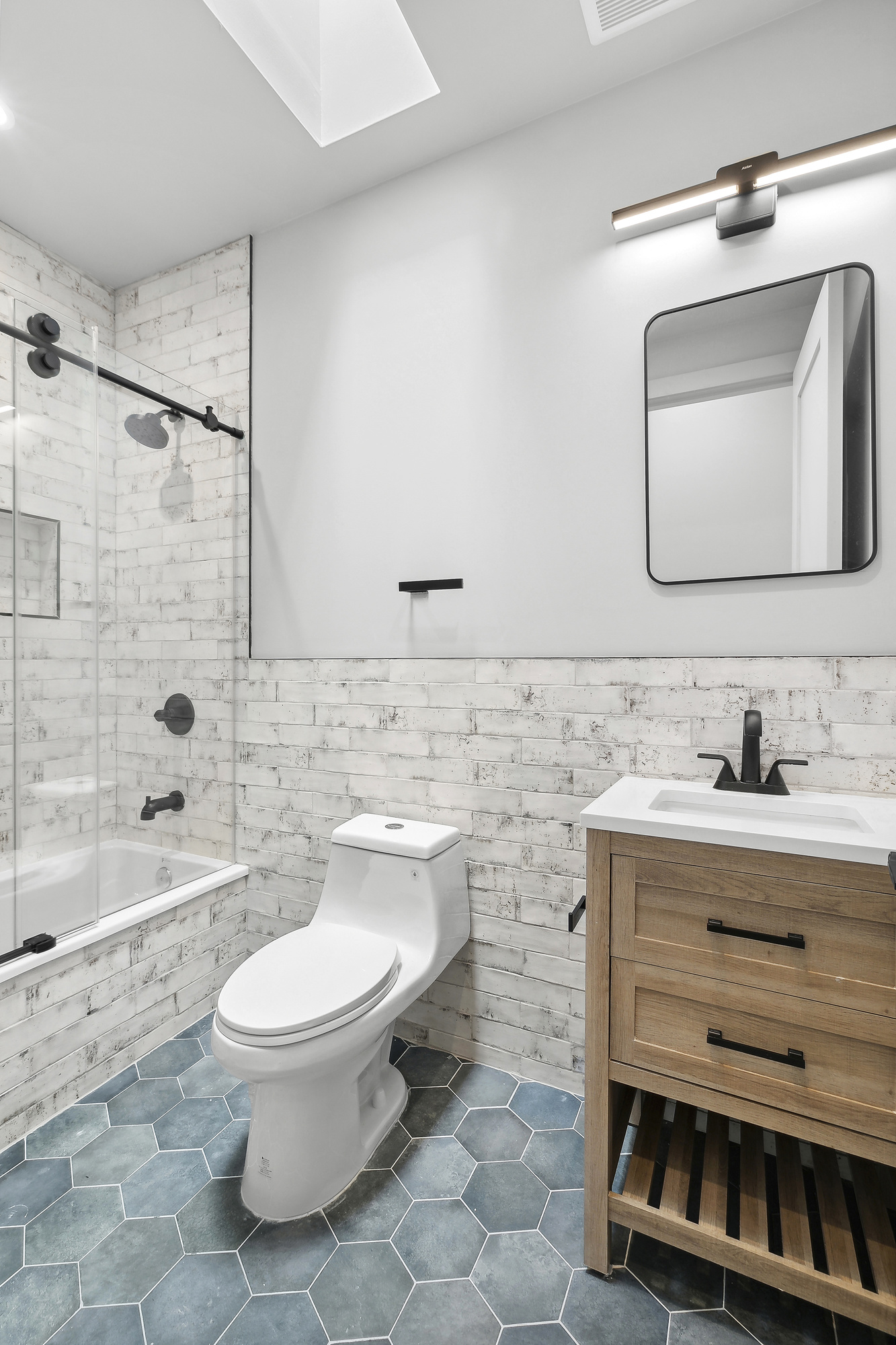 866 Bushwick Avenue, Unit 3 Brooklyn, NY 11221 - Photo 5 of 13 a bathroom with a toilet sink and mirror