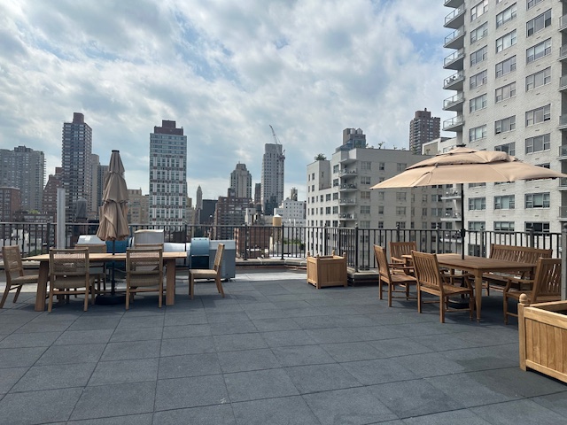 520 East 76th Street, Unit 11C Manhattan, NY 10021 - Photo 14 of 15 a view of a terrace with chairs and a barbeque