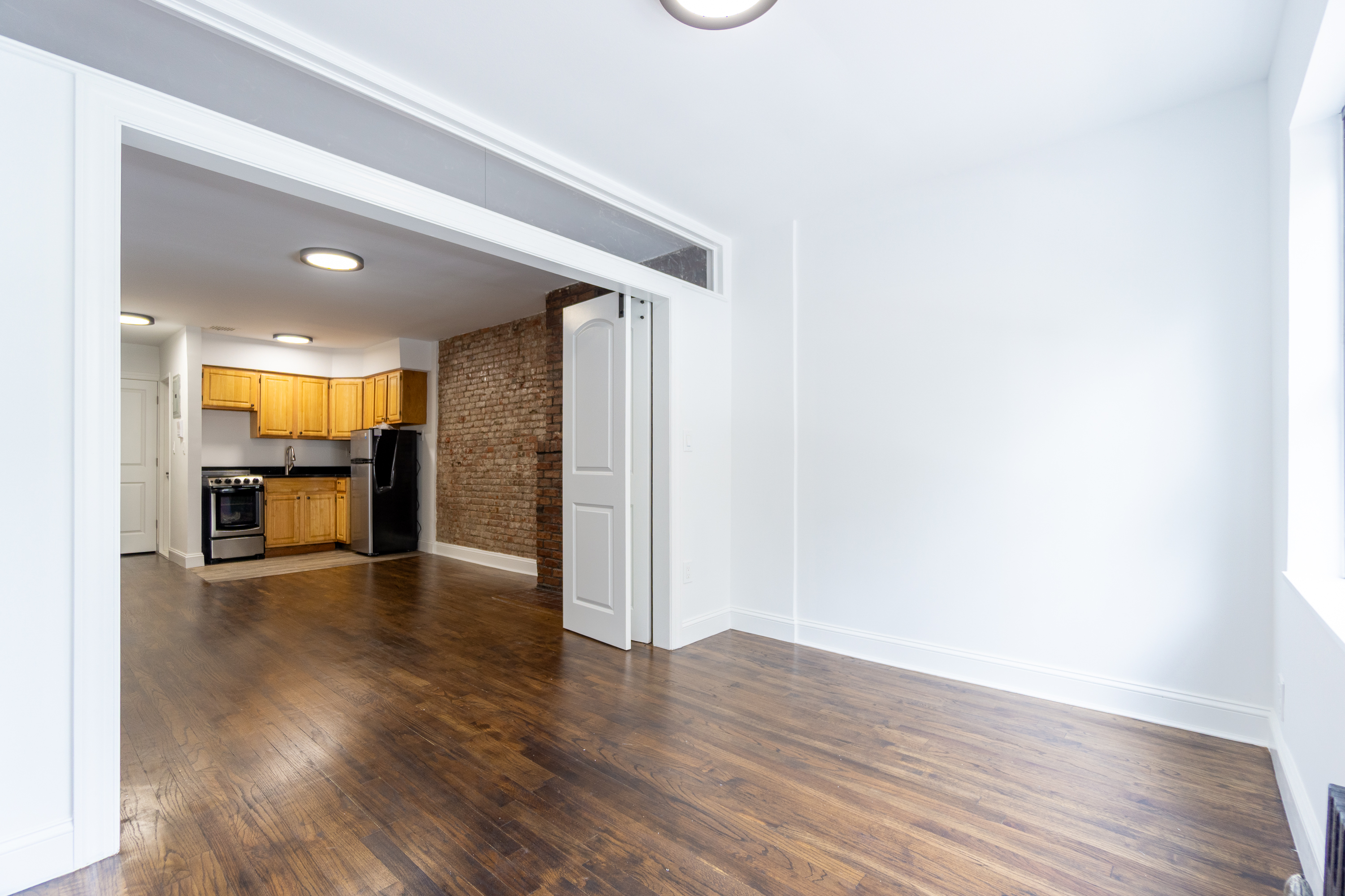 205 2nd Avenue, Unit 3B Manhattan, NY 10003 - Photo 5 of 9 a view of an empty room with wooden floor