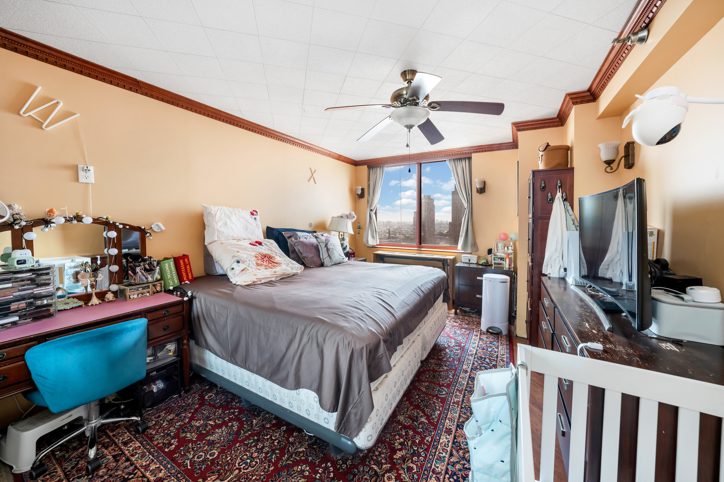 4-74 48th Avenue, Unit 27A Queens, NY 11109 - Photo 11 of 17 a bed room with a bed and a chair