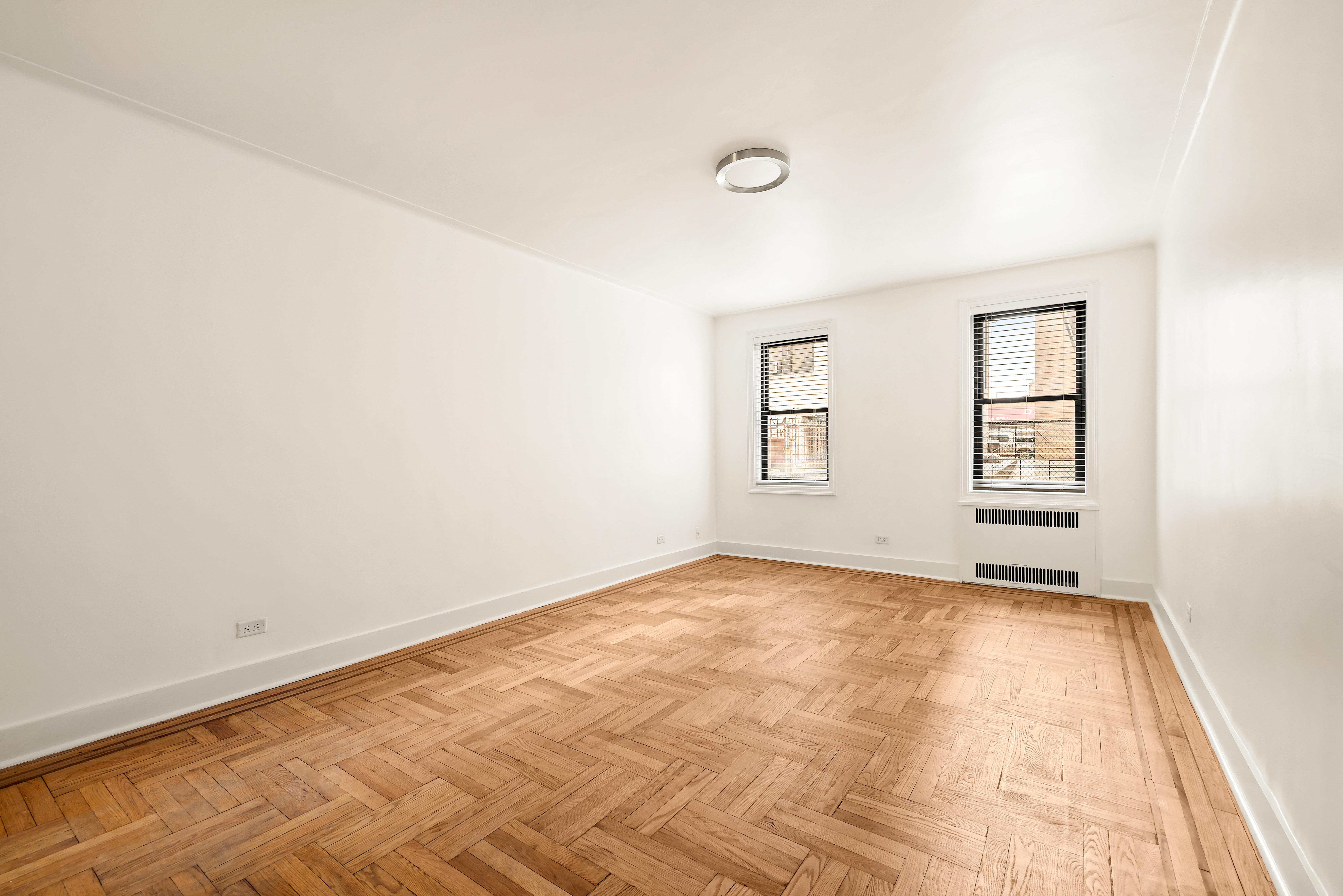 47-39 40th Street, Unit 1B Queens, NY 11104 - Photo 5 of 15 a view of an empty room and window