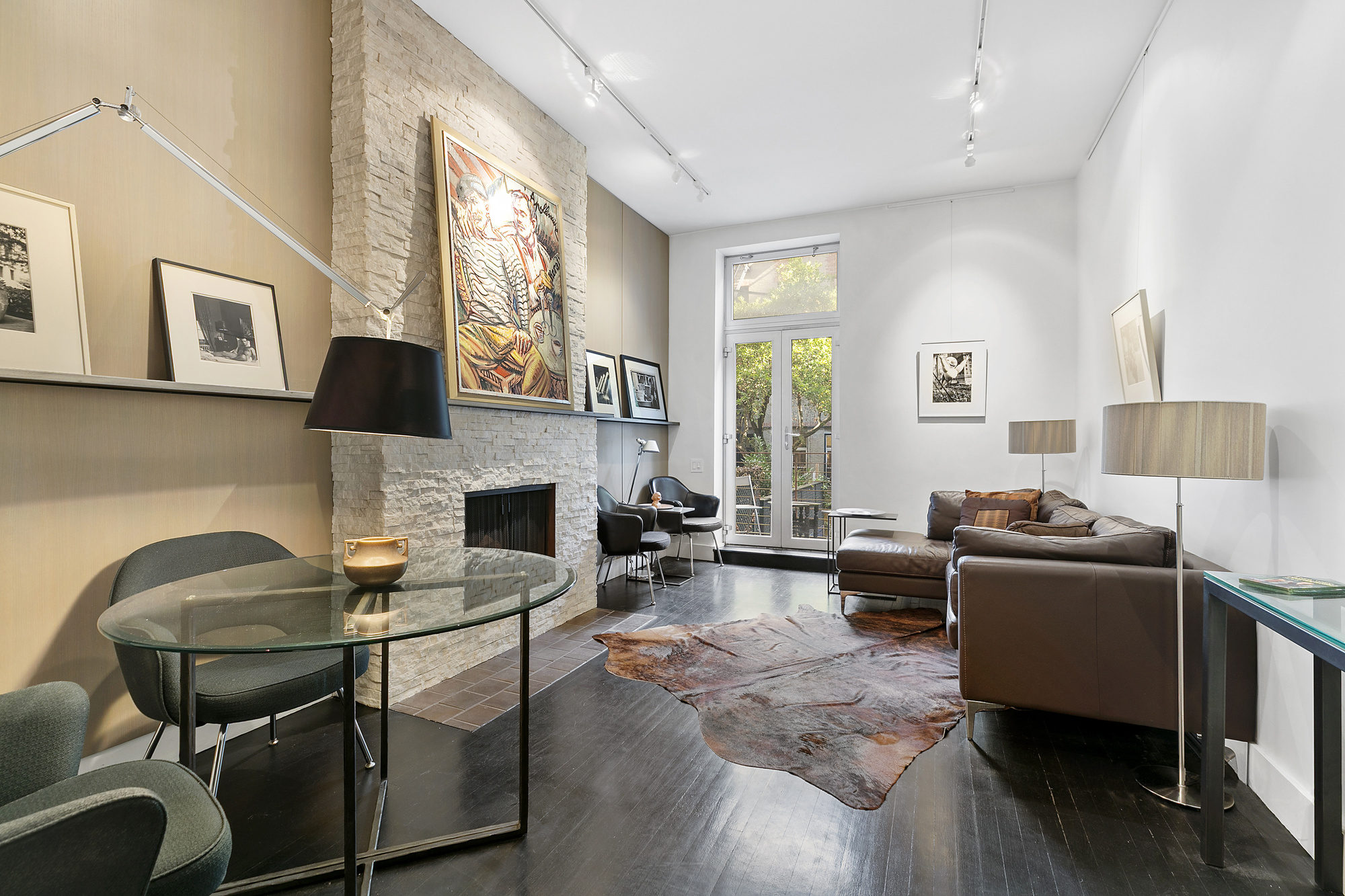 133 East 15th Street, Unit 1B Manhattan, NY 10003 - Photo 1 of 12 a living room with furniture a flat screen tv and a fireplace