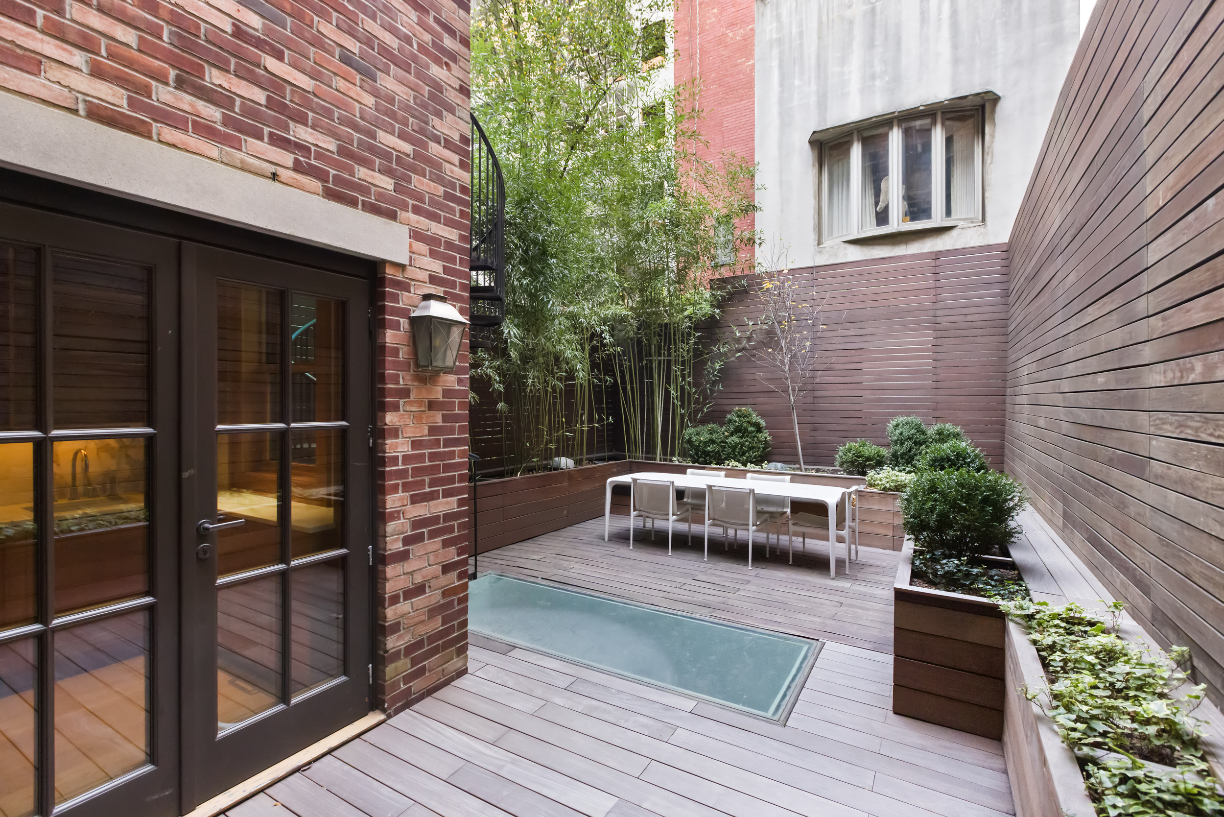 45 East 74th Street Manhattan, NY 10021 - Photo 31 of 33 a balcony with wooden floor and glass door