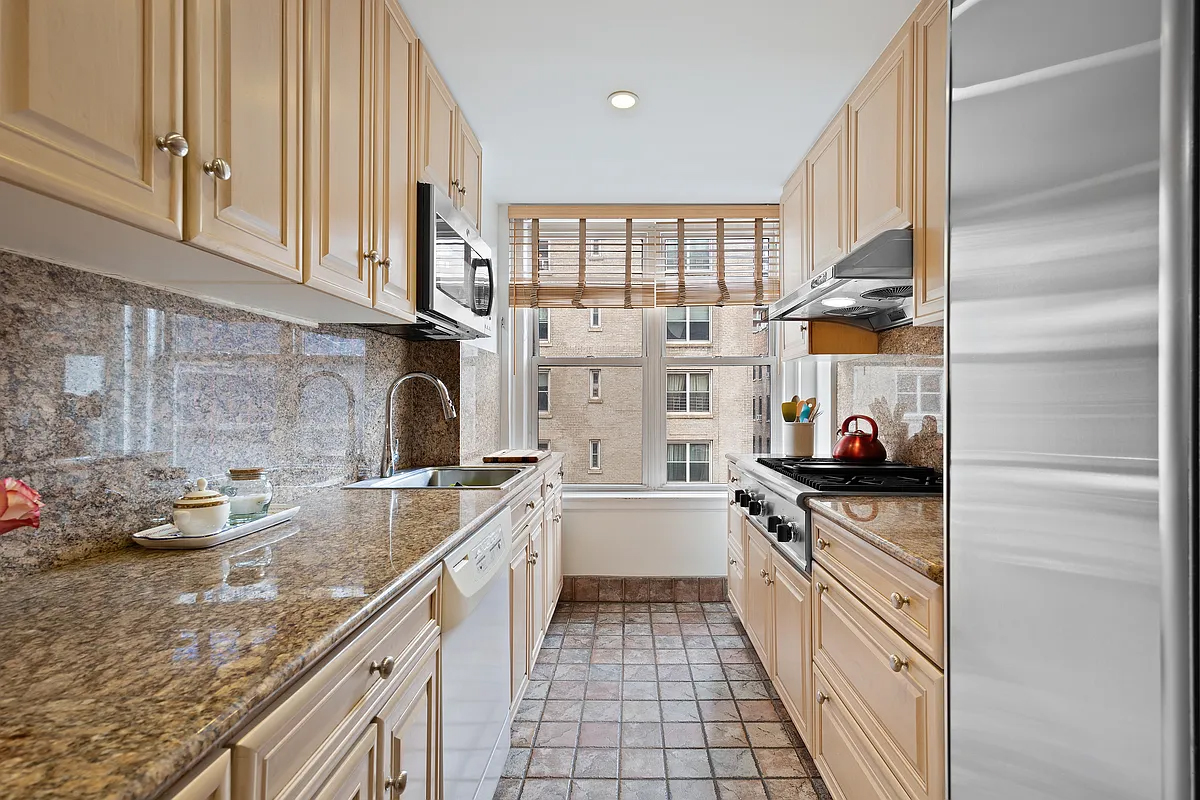 415 Central Park West, Unit 6A Manhattan, NY 10025 - Photo 14 of 25 a kitchen with a sink stove and cabinets