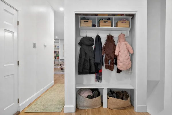 a view of walk in closet with clothes and shoes