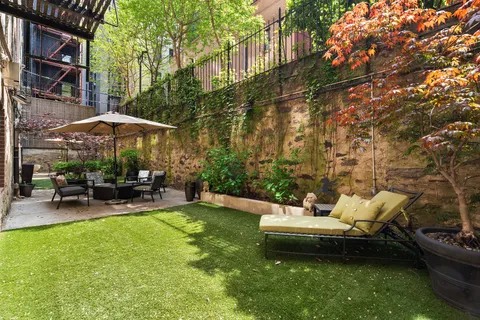 a view of a backyard with sitting area and furniture
