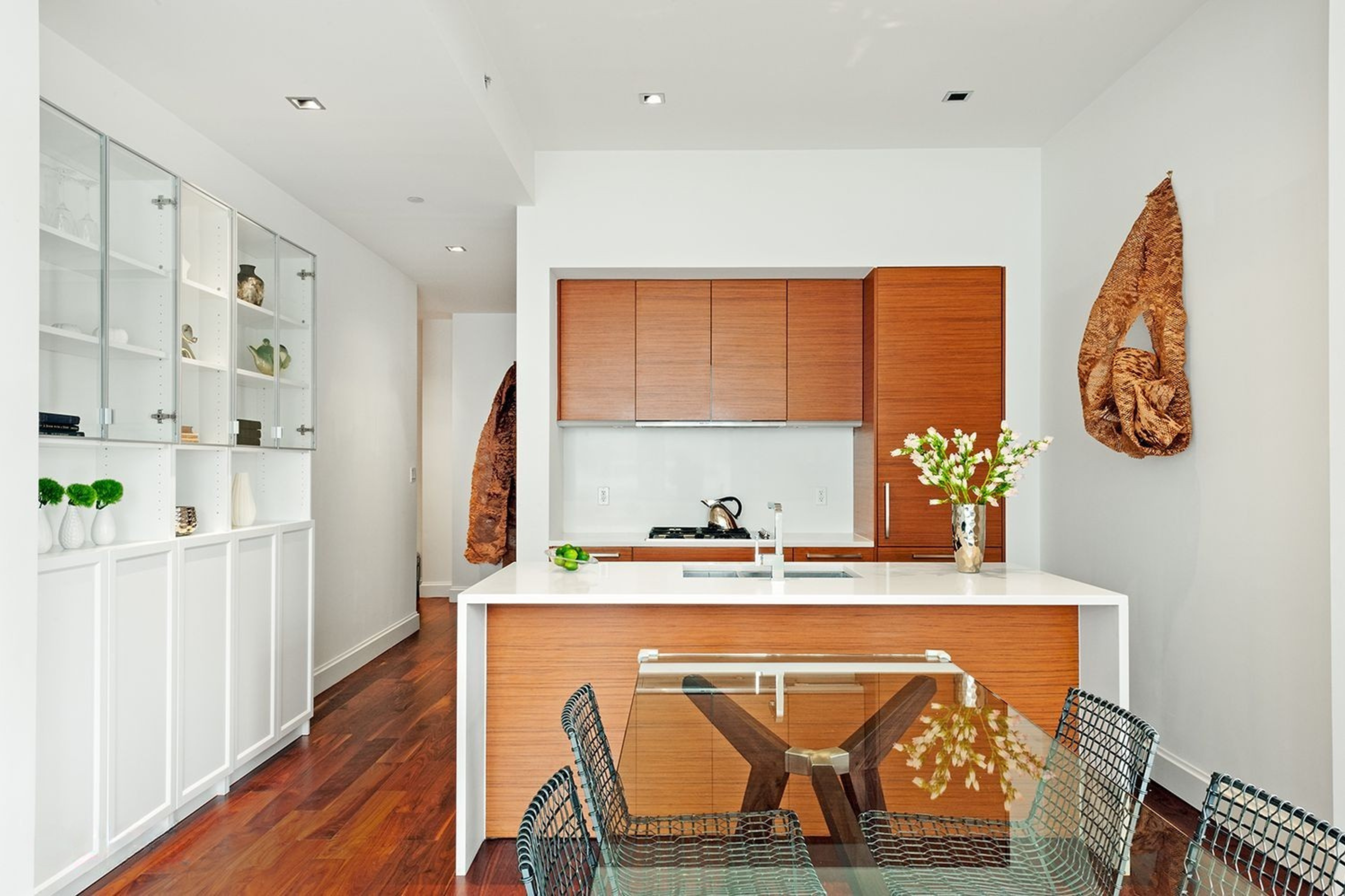 140 West 22nd Street, Unit 9A Manhattan, NY 10011 - Photo 2 of 9 a dining room with stainless steel appliances furniture a rug and a kitchen view