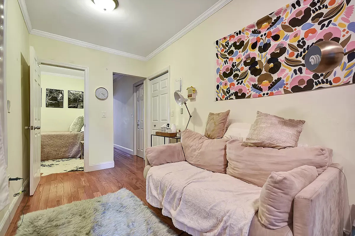 1273 1st Avenue, Unit 8 Manhattan, NY 10065 - Photo 4 of 6 a spacious bedroom with a large bed and a wooden floor