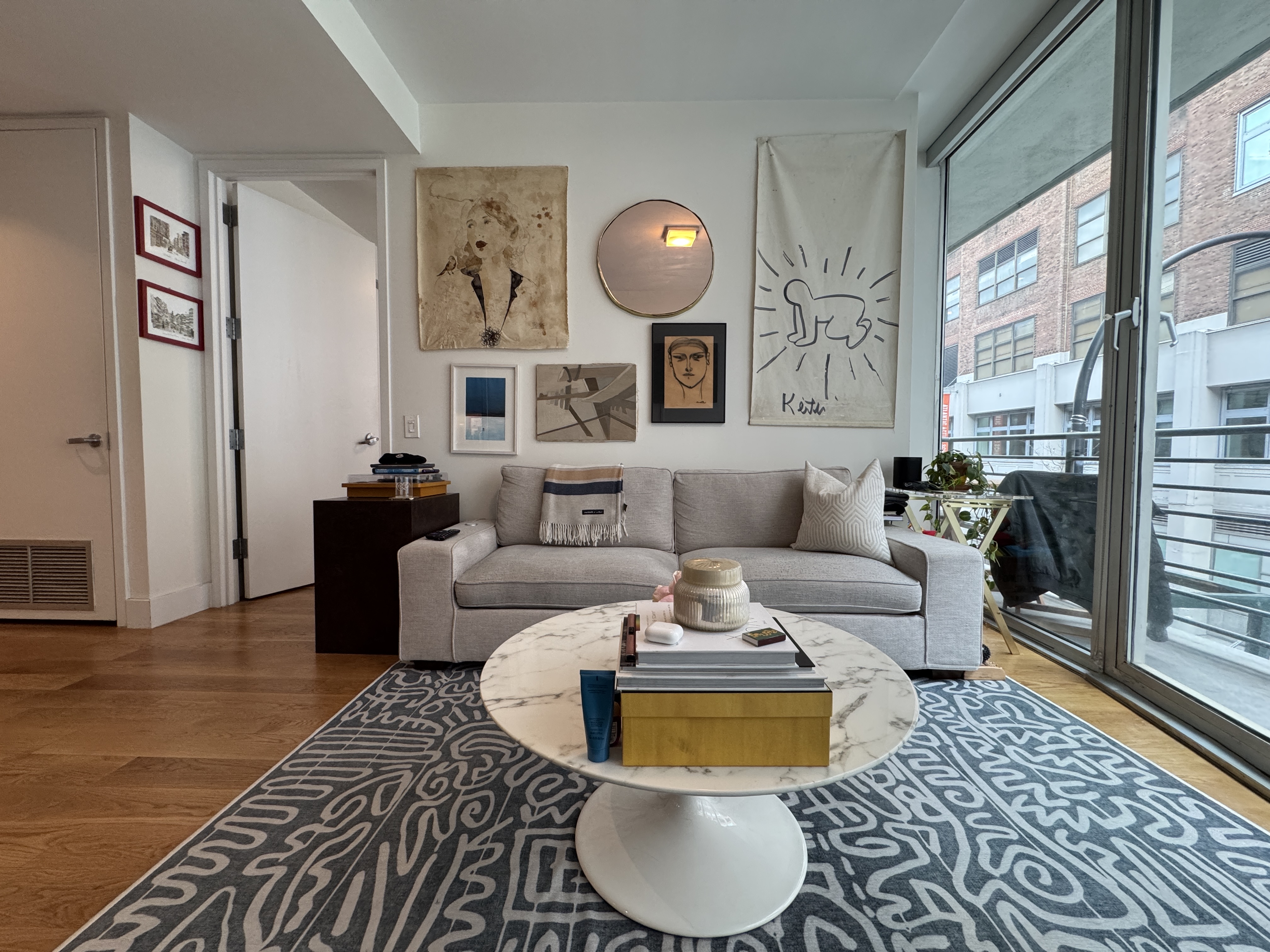 343 West 16th Street, Unit 3F Manhattan, NY 10011 - Photo 3 of 10 a living room with furniture a rug and a large window