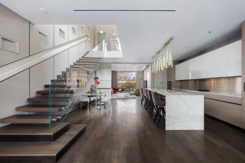a view of entryway and kitchen with wooden floor