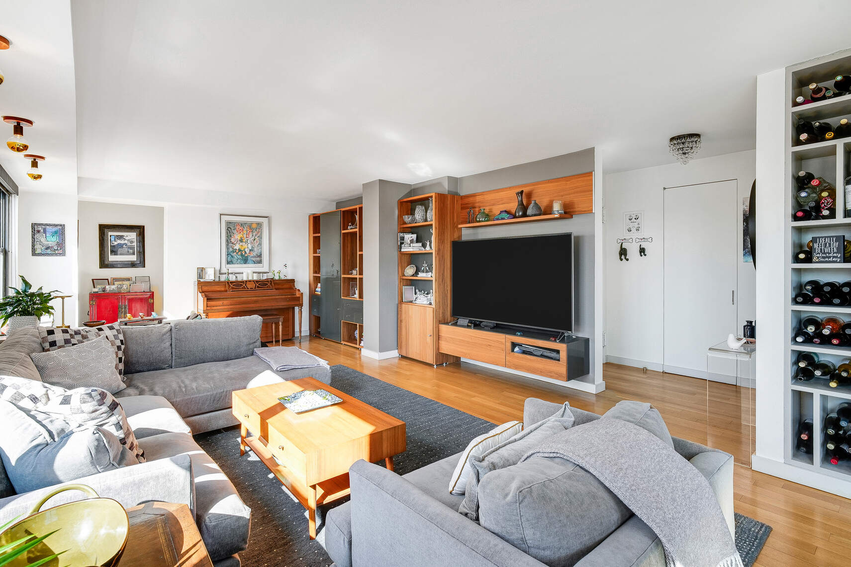 201 East 28th Street, Unit 21BC Manhattan, NY 10016 - Photo 10 of 24 a living room with furniture and a flat screen tv