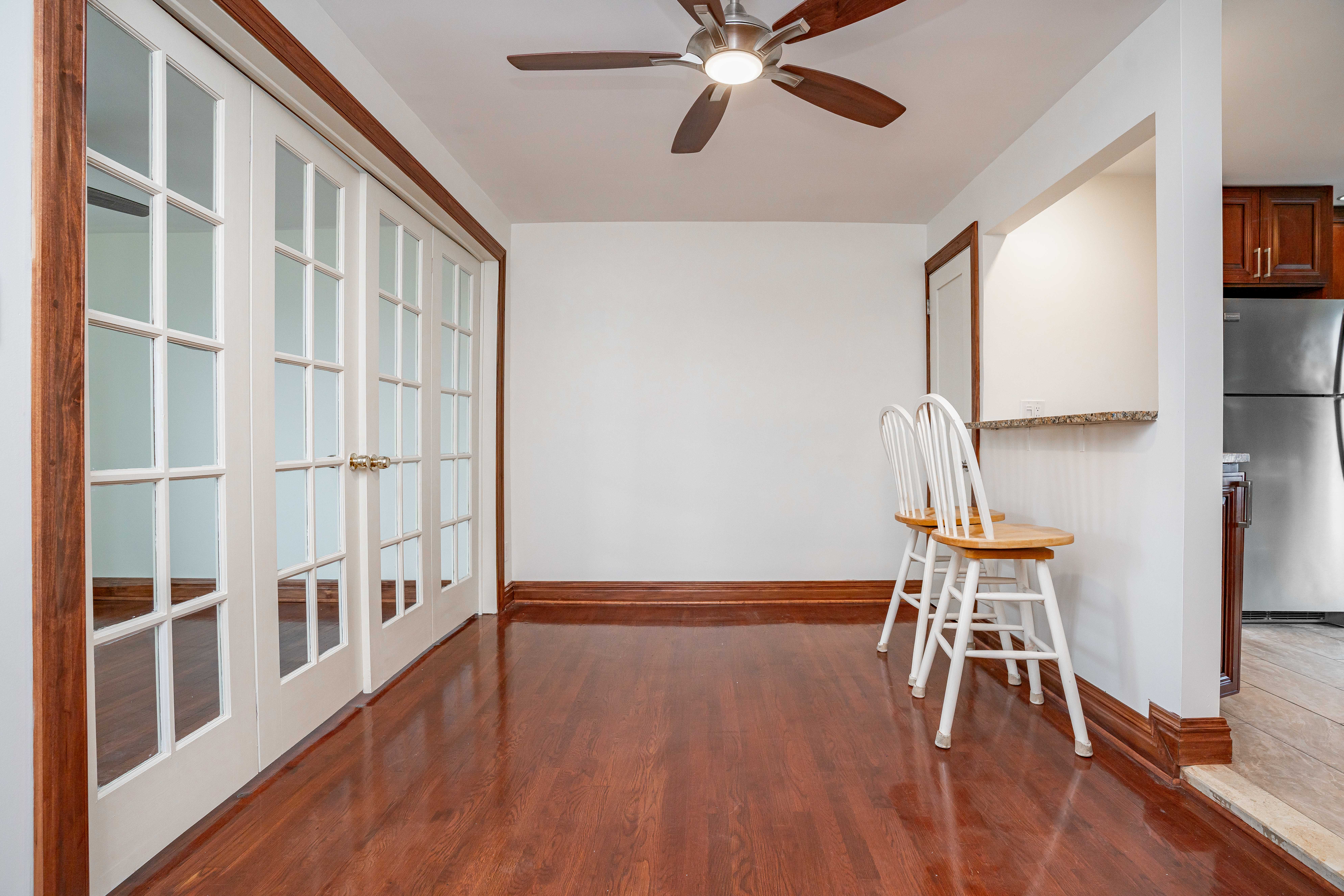 20-60 33rd Street, Unit 2 Queens, NY 11105 - Photo 2 of 10 a view of a dining room with furniture a chandelier and wooden floor