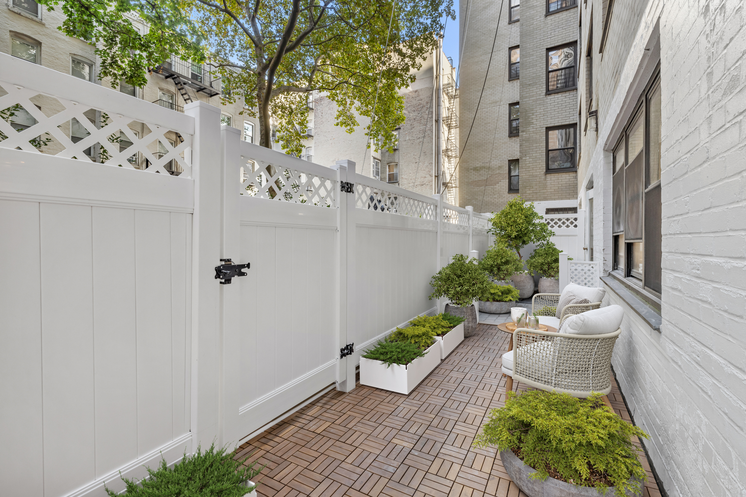 315 East 65th Street, Unit 1A Manhattan, NY 10065 - Photo 6 of 12 a front view of a house with a yard