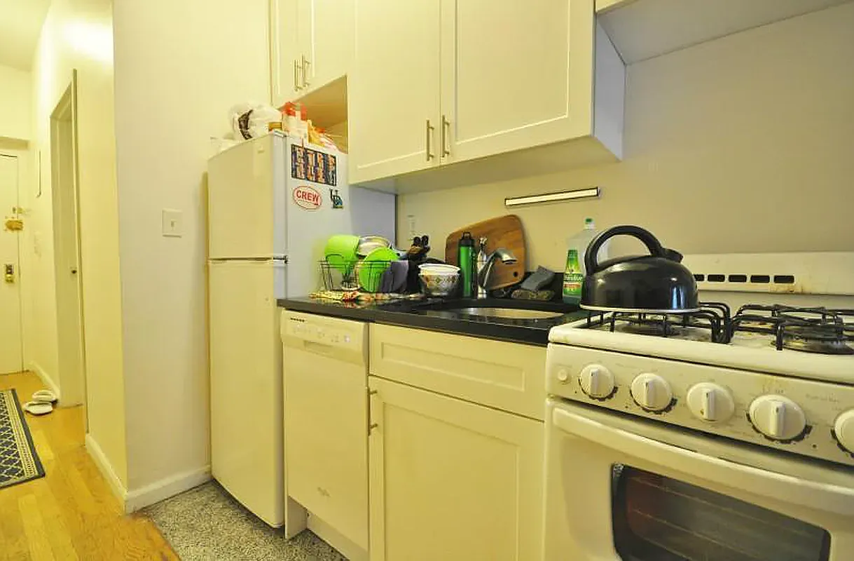 416 East 71st Street, Unit 21 Manhattan, NY 10021 - Photo 5 of 5 a close view of a sink and dishwasher with a dining table
