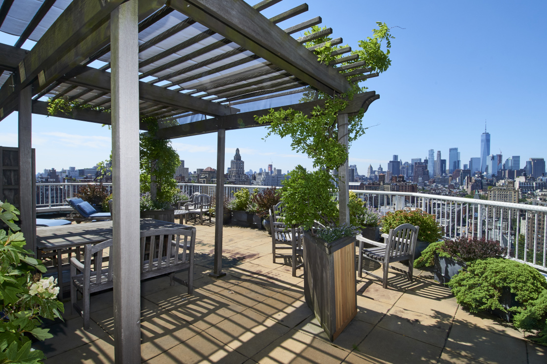 101 West 12th Street, Unit 15JK Manhattan, NY 10011 - Photo 20 of 22 a view of a chair and tables in the patio
