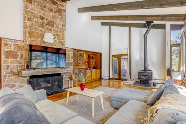 a living room with furniture and a floor to ceiling window