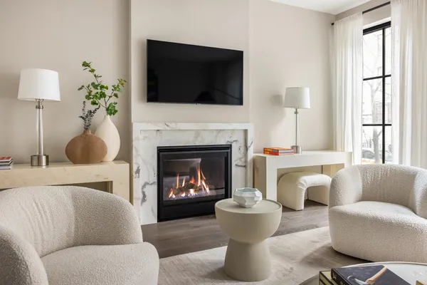 a living room with furniture a fireplace and a flat screen tv
