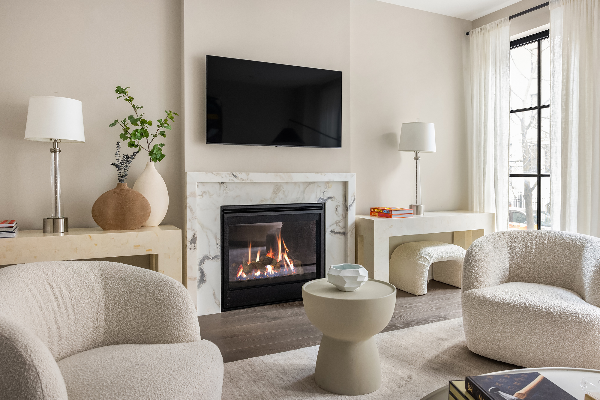 123 East 61st Street Manhattan, NY 10065 - Photo 4 of 31 a living room with furniture a fireplace and a flat screen tv
