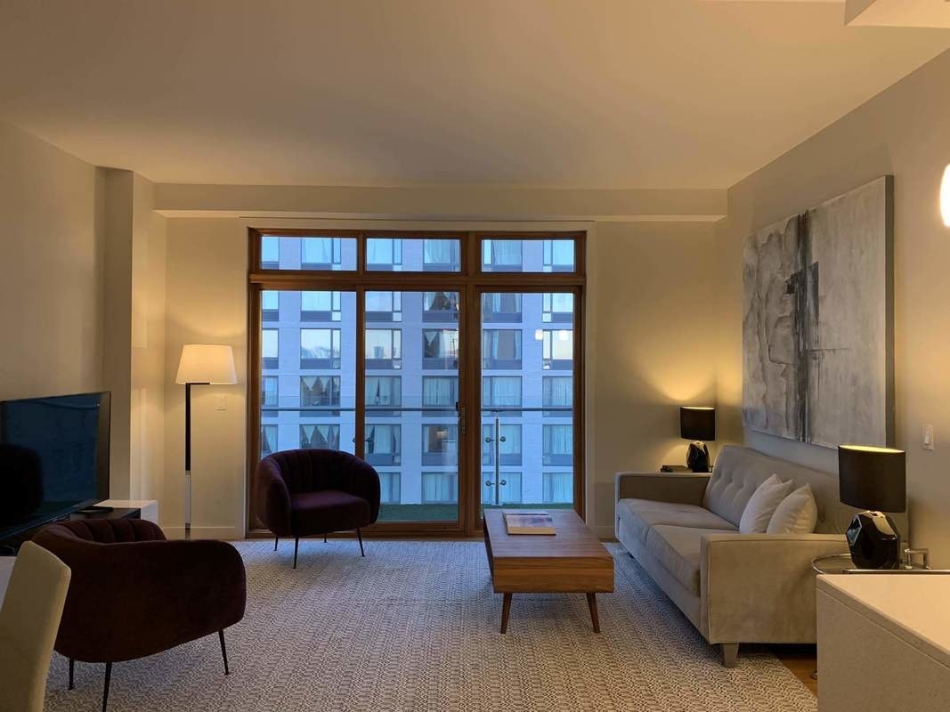 548 4th Avenue, Unit 4B Brooklyn, NY 11215 - Photo 18 of 22 a living room with furniture and a lamp