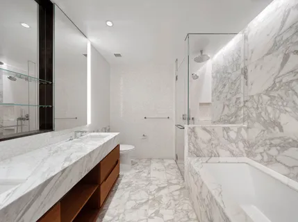 a spacious bathroom with a tub sink and shower