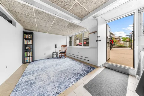 a view of a livingroom with wooden floor and white walls