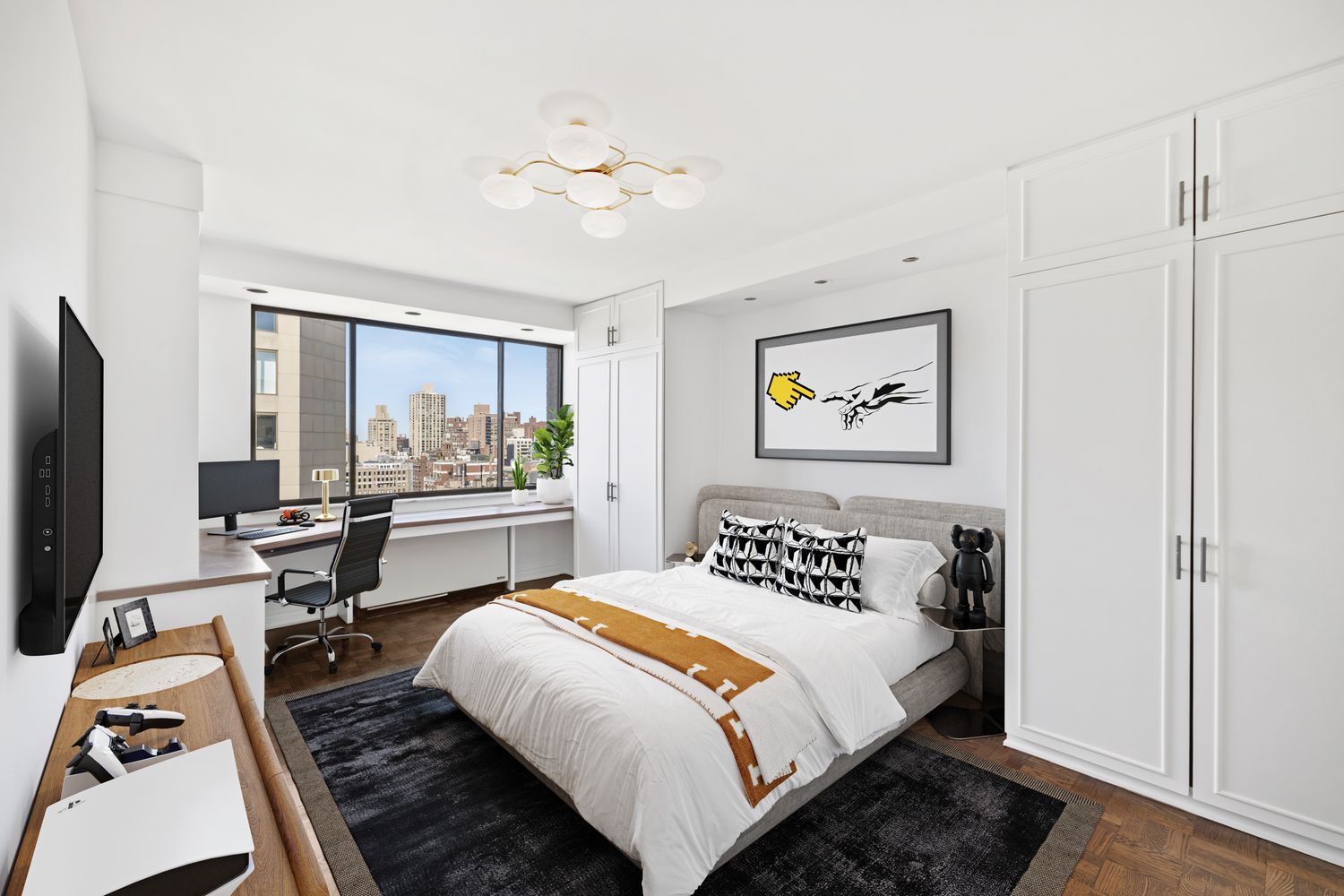 40 East 80th Street, Unit 25A Manhattan, NY 10075 - Photo 12 of 18 a bedroom with a bed and a chandelier