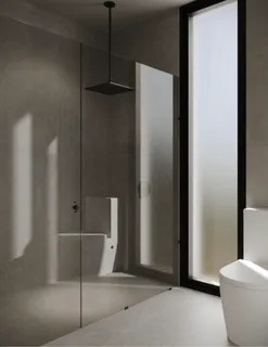 a bathroom with a shower and toilet