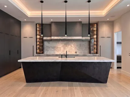 a kitchen with stainless steel appliances granite countertop a sink a counter space and wooden floor