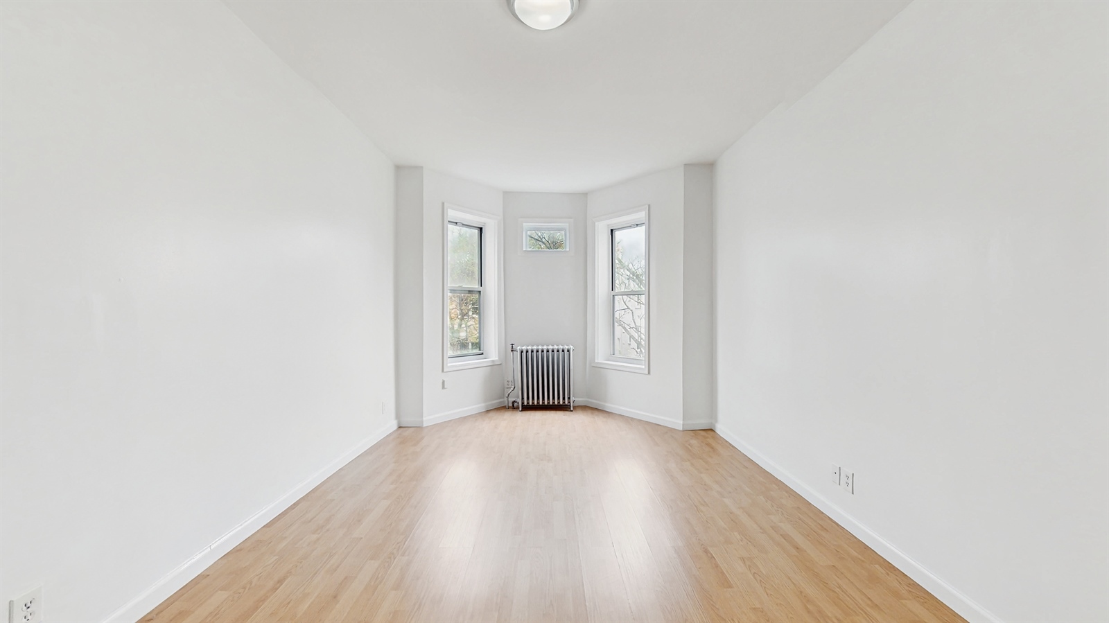 454 77th Street, Unit 3 Brooklyn, NY 11209 - Photo 6 of 25 a view of a room with wooden floor and white walls