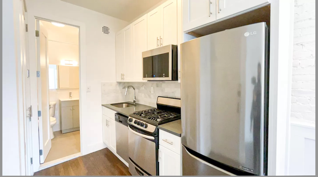 1736 2nd Avenue, Unit 4A Manhattan, NY 10128 - Photo 3 of 6 a kitchen with stainless steel appliances a refrigerator and a stove