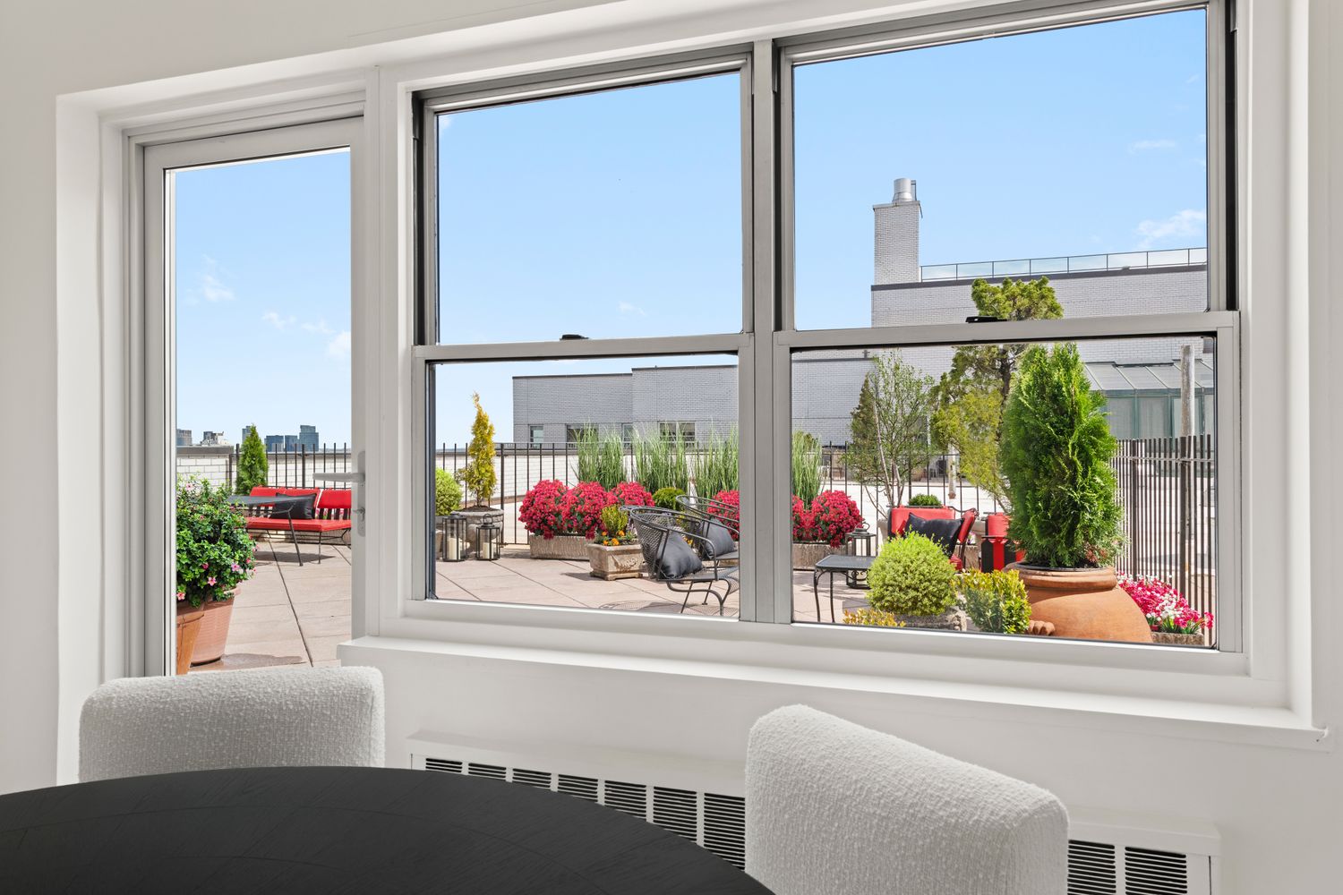 a front view of a house with a window and sitting area