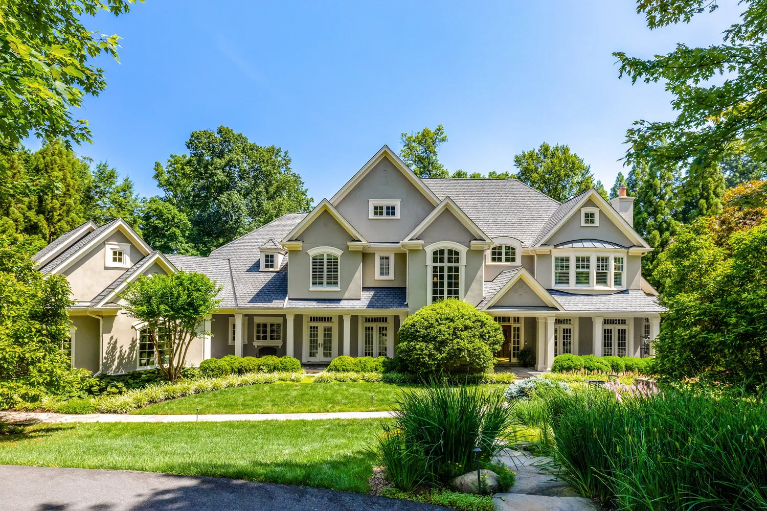 a front view of a house with a garden
