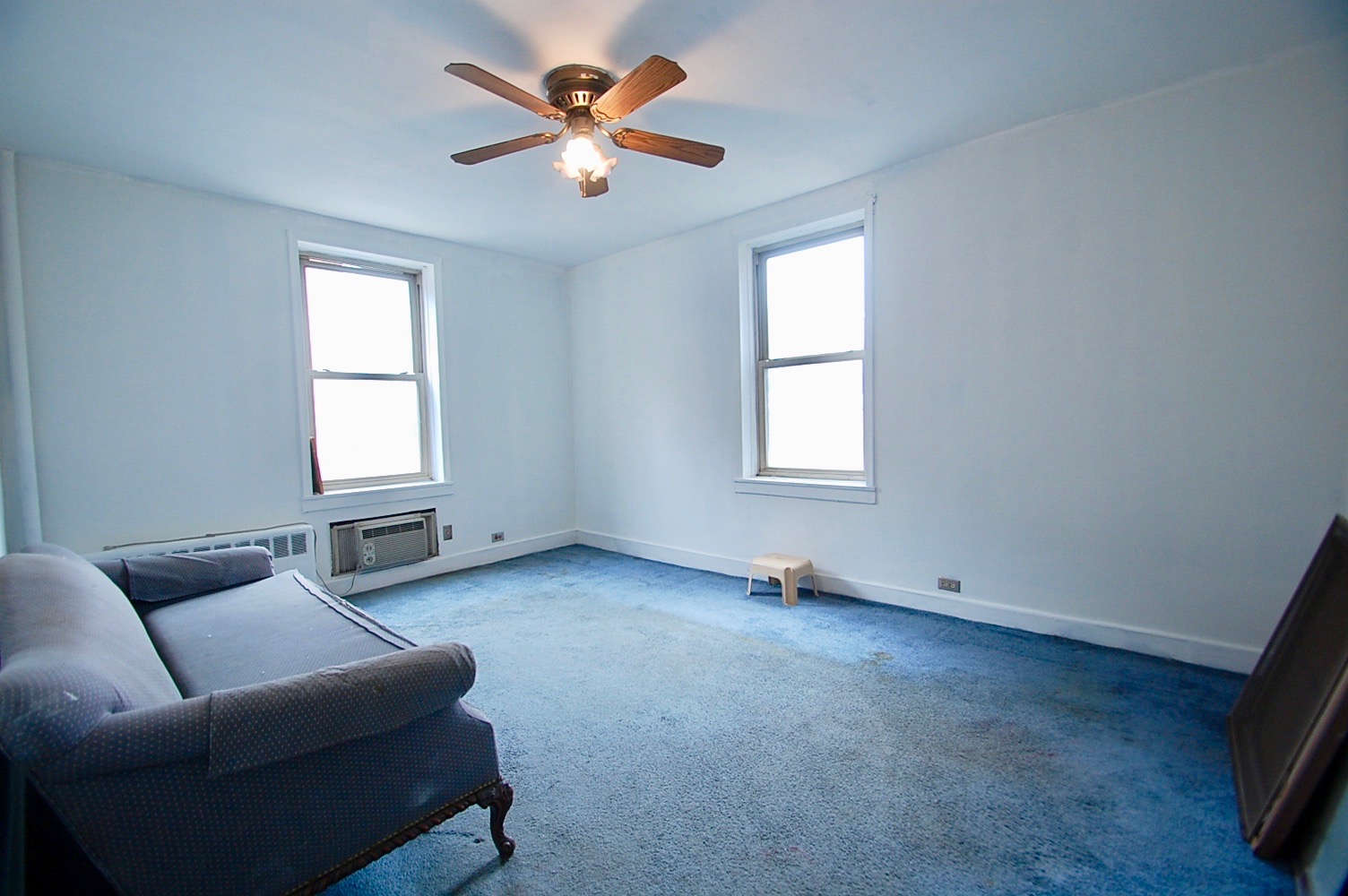 43-10 48th Avenue, Unit 2P Queens, NY 11377 - Photo 2 of 9 a living room with furniture and a window