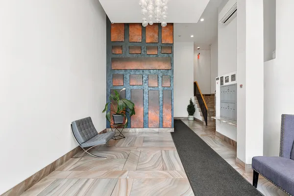 a hallway with a couch and a potted plant