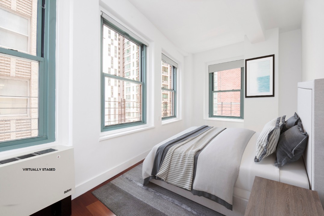 80 John Street, Unit 4C Manhattan, NY 10038 - Photo 8 of 11 a bedroom with a bed and wooden floor