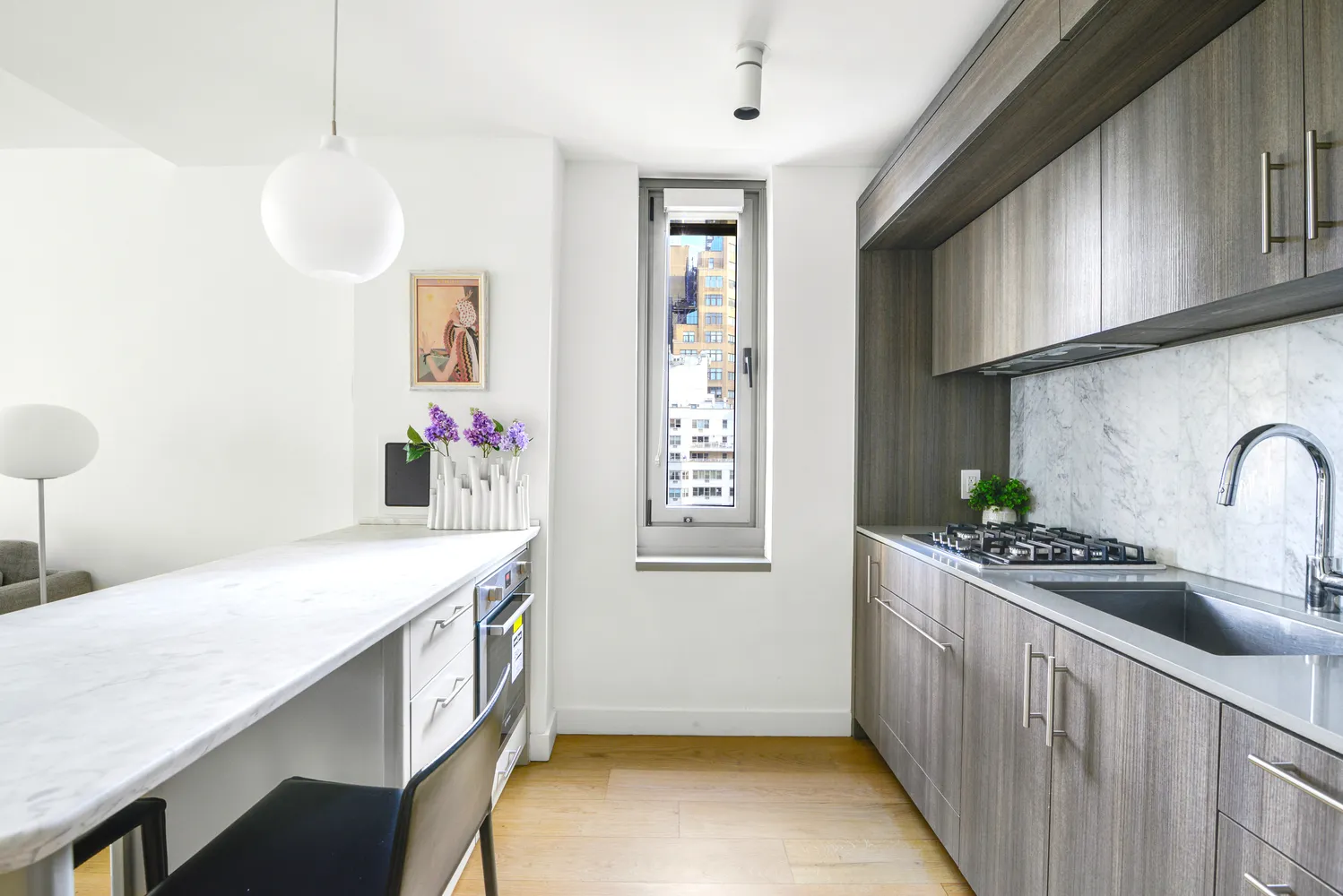 a kitchen with stainless steel appliances a stove a sink dishwasher and cabinets with wooden floor