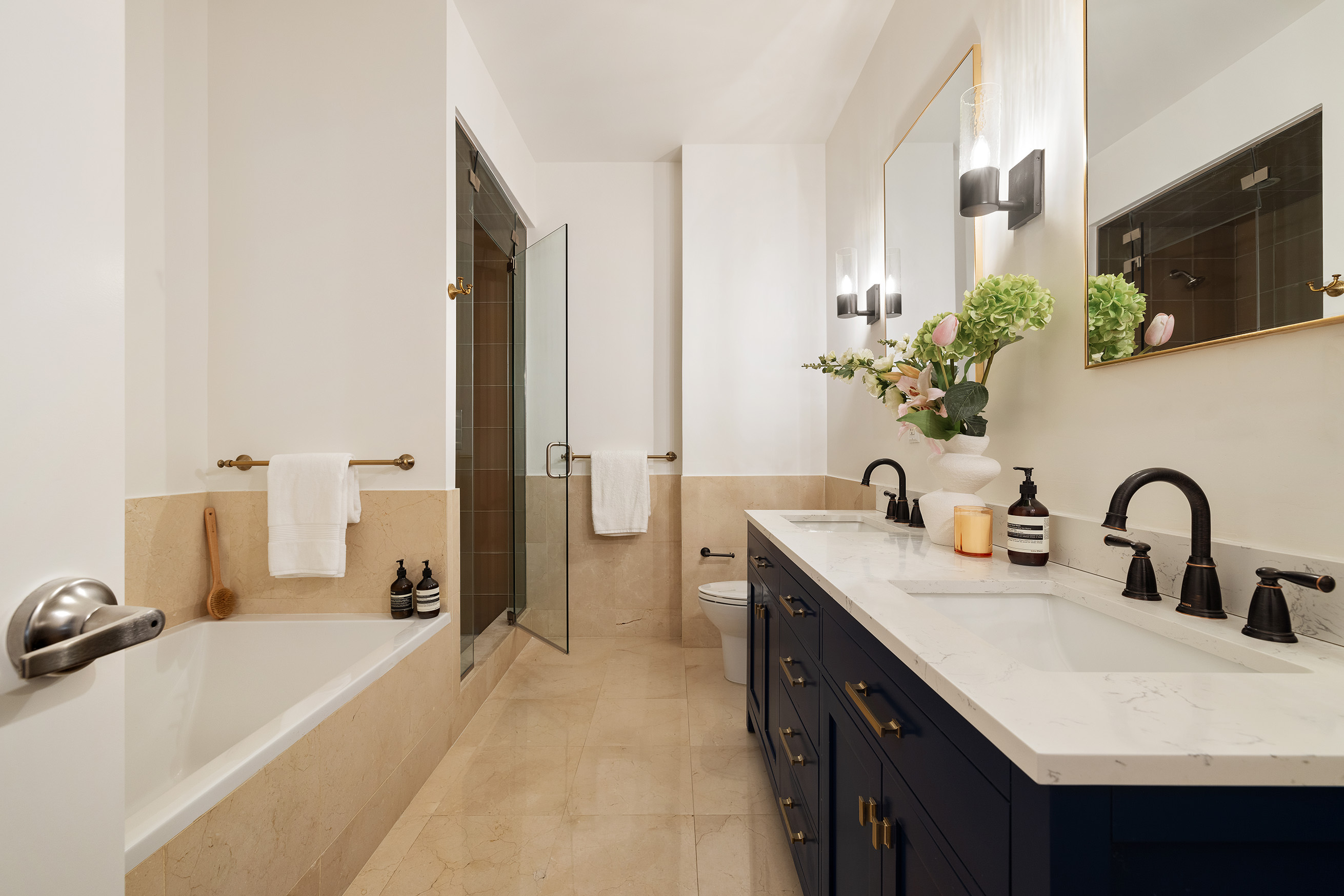 42 East 20th Street, Unit 4AD Manhattan, NY 10003 - Photo 12 of 19 a bathroom with a double sink sink and a mirror