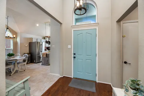 a view of a hallway with workspace and living room