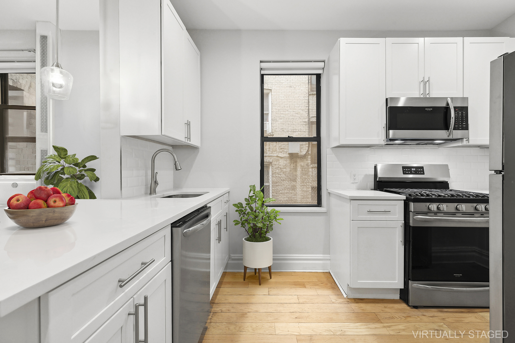 961 Washington Avenue, Unit 1I Brooklyn, NY 11225 - Photo 4 of 8 a kitchen with stainless steel appliances a sink dishwasher stove refrigerator and microwave with wooden floor