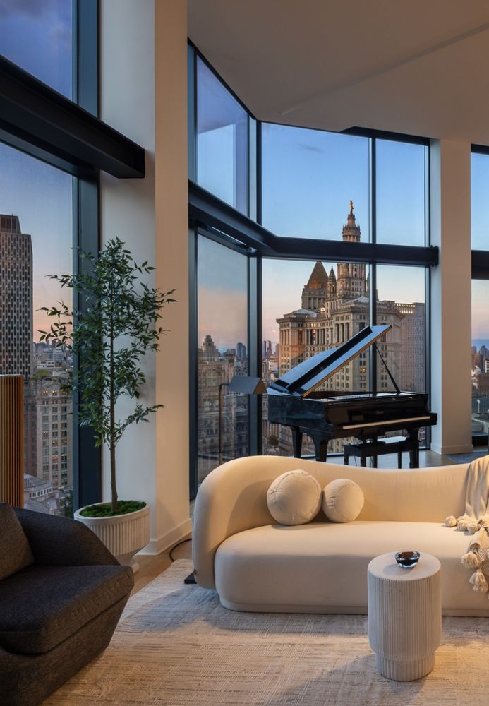 a living room with furniture a couch and potted plants