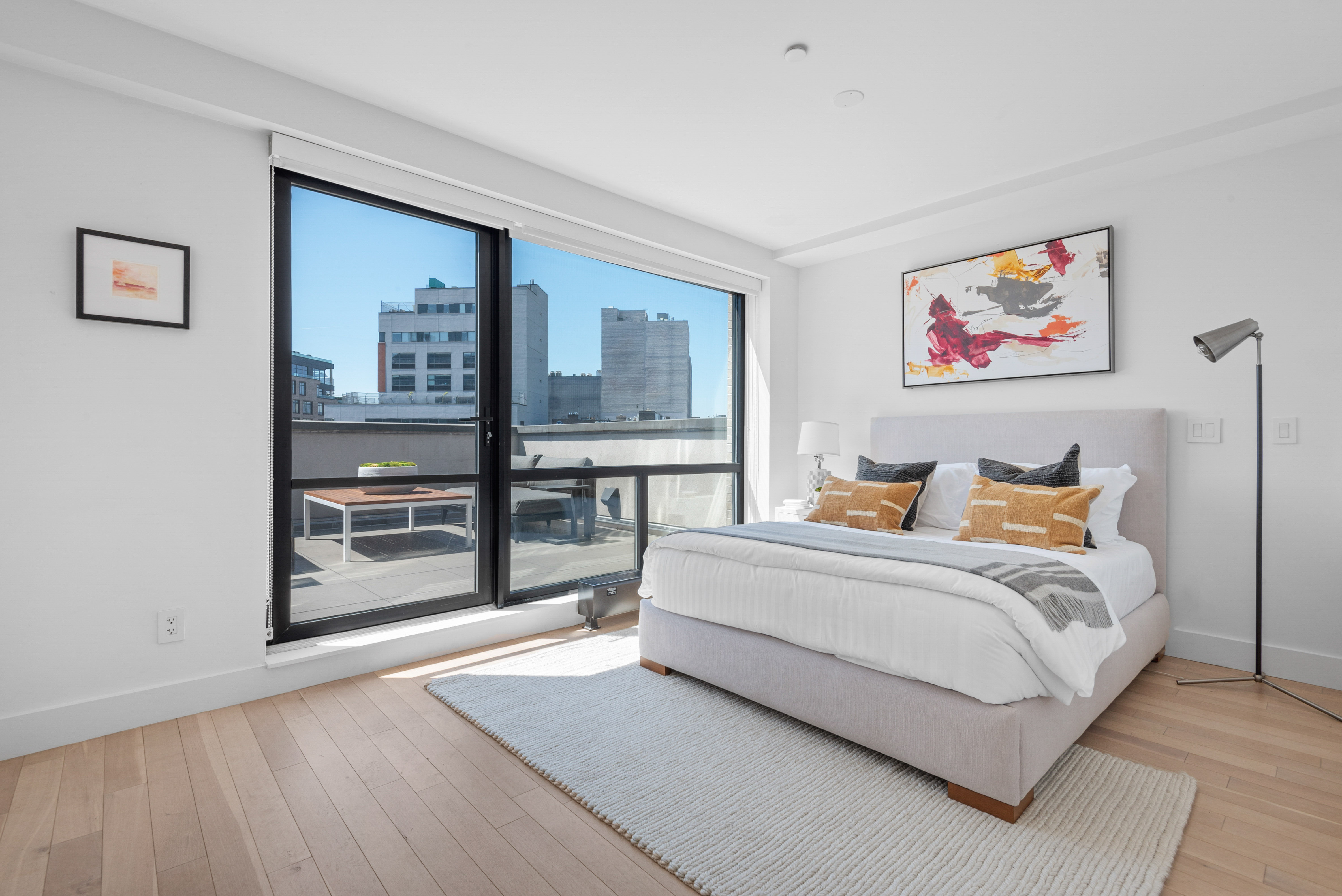 476 Union Avenue, Unit PH5A Brooklyn, NY 11211 - Photo 8 of 17 a spacious bedroom with a bed and a desk