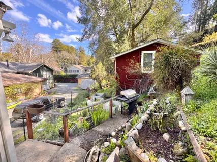 a backyard of a house with table and chairs